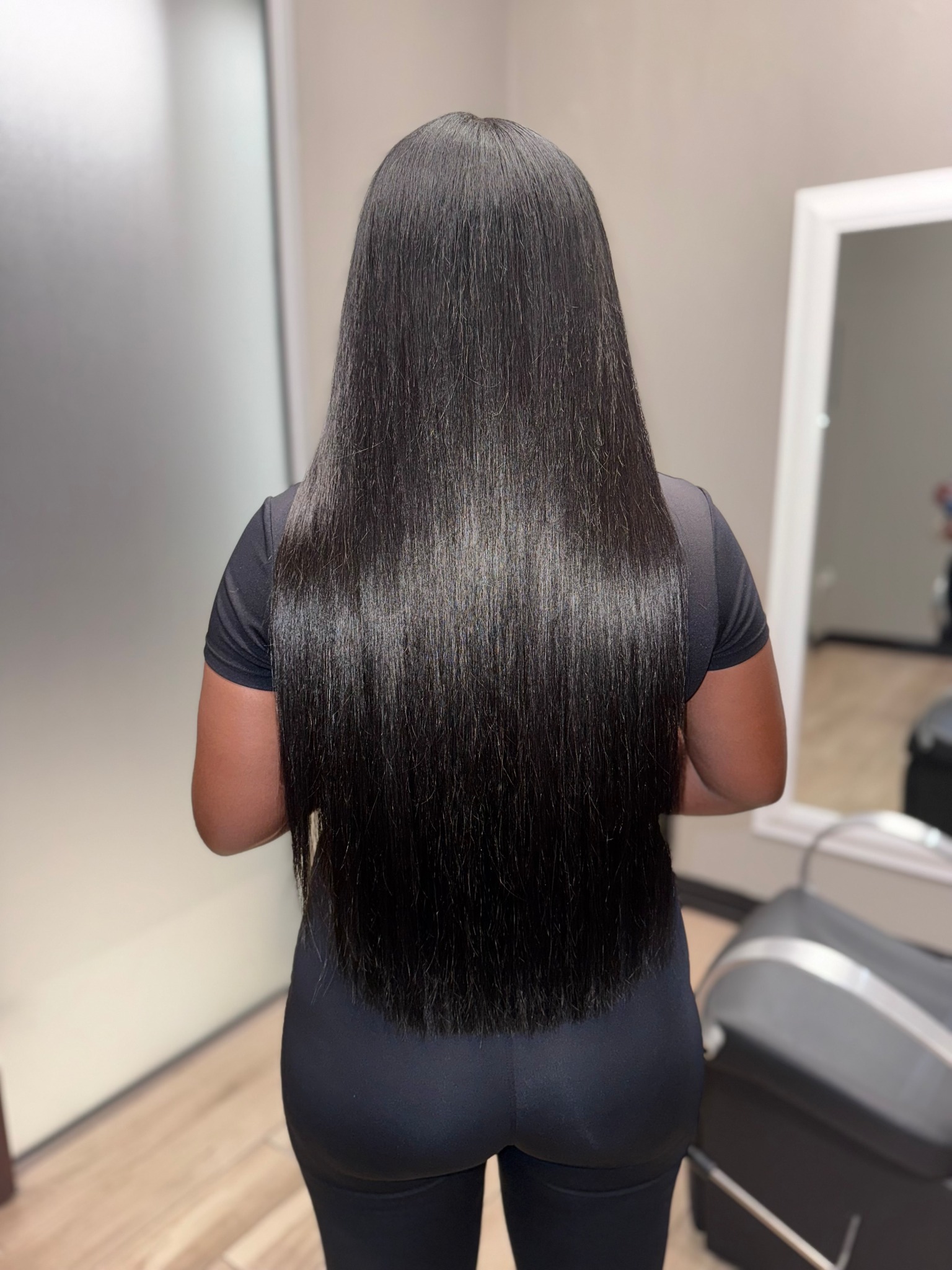 Braidless sew-in extensions back view long sleek hair